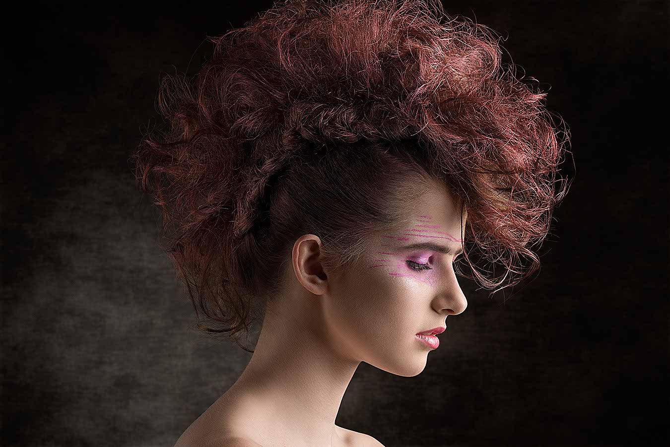 close-up beauty portrait of punk female with red rock hairdo and creative make-up. Perfect skin, aggressive fashion trendy style