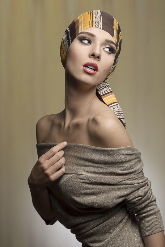 fashion woman with foulard on the head in sensual pose with naked shoulders and brown dress